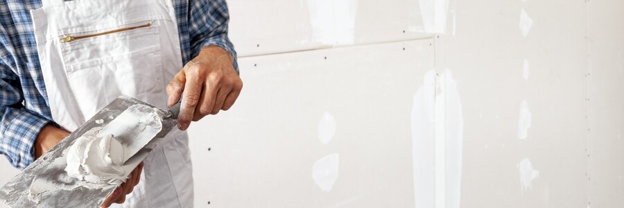 Drywall repair being performed by an experienced Henderson Custom Painting LLC drywall technician.